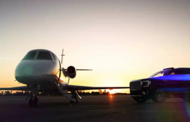 Private jet and an SUV on the airport ramp at sunset